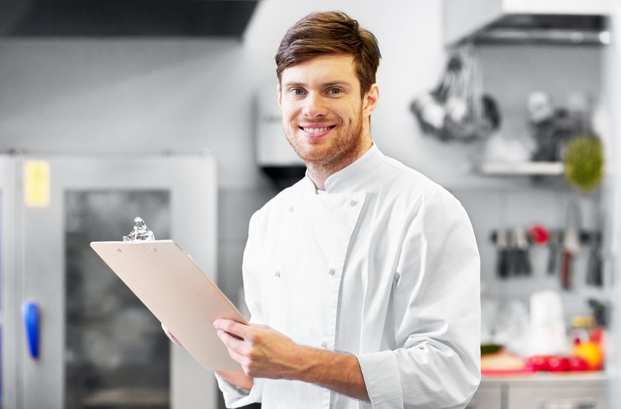chef with clipboard doing inventory at restaurant
